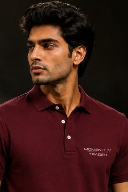 Man wearing a maroon polo shirt with 'Momentum Trader' logo on a dark background