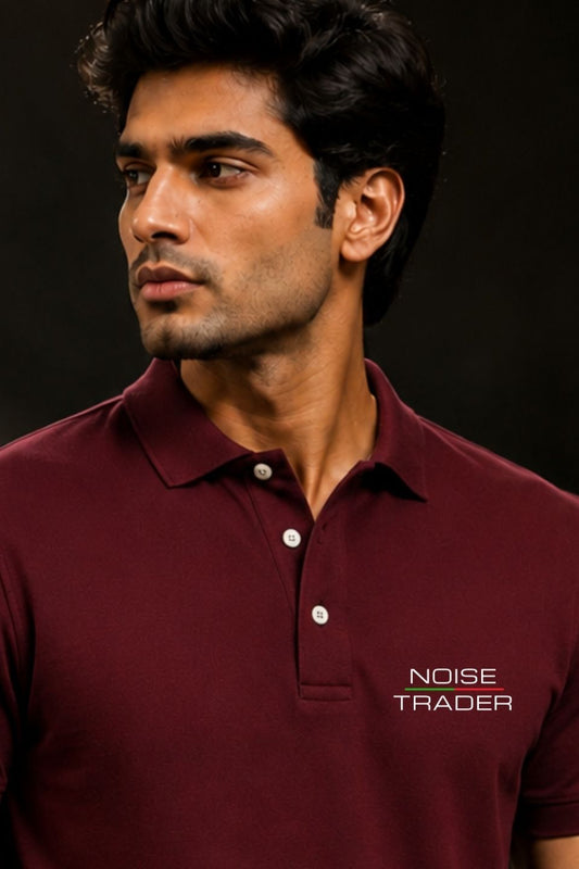 Man wearing a maroon polo shirt with 'Noise Trader' branding on a dark background