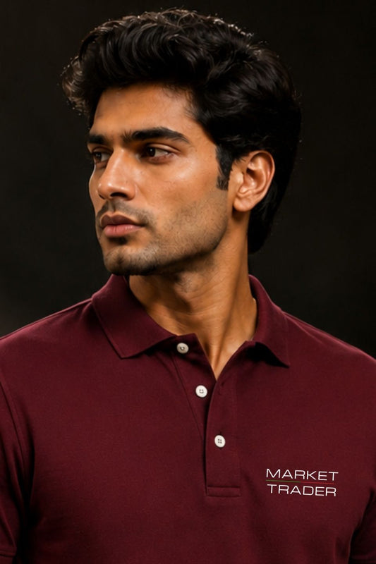 Man wearing a maroon polo shirt with 'Market Trader' logo on a dark background