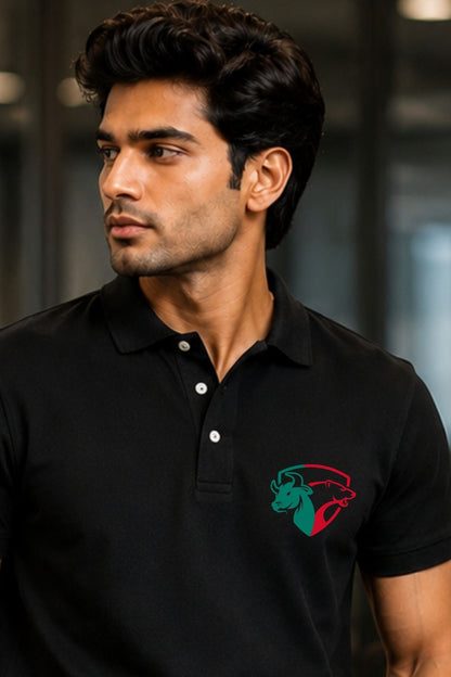 Man wearing a black polo shirt with a logo on a blurred background